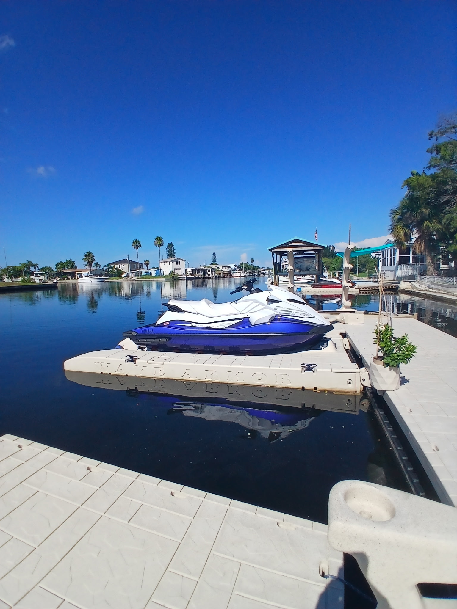 Drive-on PWC port with adjustable rollers attached to a floating dock